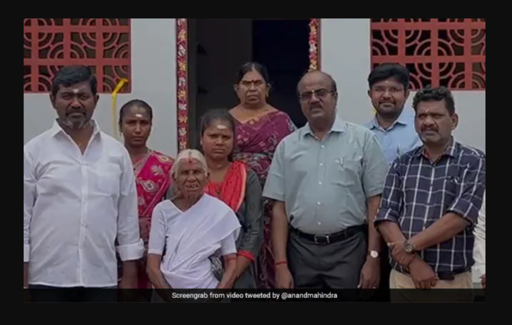 M Kamalathal, fondly known as 'Idli Amma', stands in front of her new house.